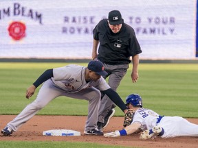 Jonathan Schoop of the Detroit Tigers tags out Andrew Benintendi of the Kansas City Royals in the first inning at Kauffman Stadium on May 21, 2021 in Kansas City, Missouri.