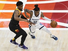 Ja Morant of the Memphis Grizzlies drives around Donovan Mitchell of the Utah Jazz in Game Two of the Western Conference first-round playoff series at Vivint Smart Home Arena on May 26, 2021 in Salt Lake City, Utah.