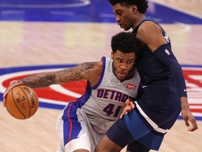 Saddiq Bey of the Detroit Pistons tries to drive around Jaden McDaniels of the Minnesota Timberwolves during the second half at Little Caesars Arena on May 11, 2021 in Detroit, Michigan.