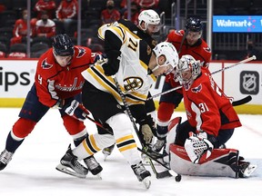 Taylor Hall of the Boston Bruins tries to get the puck past Craig Anderson of the Washington Capitals as Dmitry Orlov of the Washington Capitals defends in the first period in Game Two of the First Round of the 2021 Stanley Cup Playoffs at Capital One Arena on May 17, 2021 in Washington, DC.