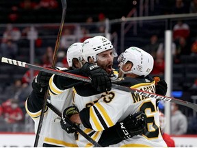 Patrice Bergeron of the Boston Bruins celebrates a third period goal with Brad Marchand against the Washington Capitals during Game Five of the 2021 Stanley Cup Playoffs at Capital One Arena on May 23, 2021 in Washington, DC.