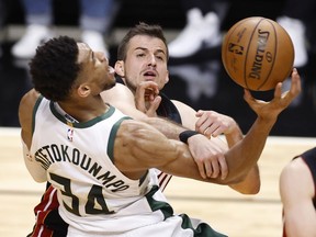 Nemanja Bjelica of the Miami Heat fouls Giannis Antetokounmpo of the Milwaukee Bucks during the fourth quarter in Game Three of the Eastern Conference first-round playoff series at American Airlines Arena on May 27, 2021 in Miami, Florida.