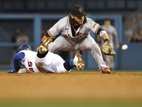 Matt Beaty of the Los Angeles Dodgers slides into second base safely as Brandon Crawford of the San Francisco Giants attempts to make the tag during the fourth inning at Dodger Stadium on May 28, 2021 in Los Angeles, California.