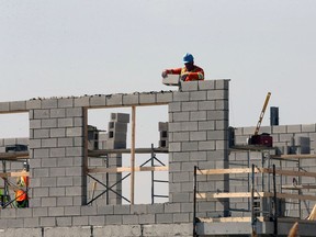 Demand for housing is increasing in Windsor, leading to more neighbourhood disputes over what's appropriate. In this March 17, 2021 file photo, construction workers and masons were busy preparing roadways and laying concrete block on portions of a new east Windsor commercial and residential development.