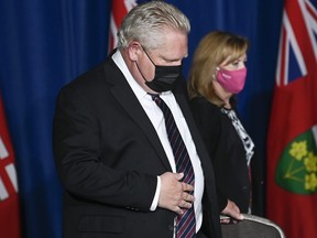 Ontario Premier Doug Ford, left, and Christine Elliott Ontario Minister of Health arrive as they holds a press conference regarding the plan for Ontario to open up at Queen's Park during the COVID-19 pandemic in Toronto May 20, 2021.
