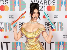 In a handout picture released by the Brit Awards, British singer-songwriter Dua Lipa poses with her awards for Female Solo Artist and British Album at the BRIT Awards 2021 in London on May 11, 2021.