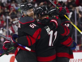 Hurricanes centre Jordan Staal (11) is congratulated by left wing Warren Foegele (13) and defenceman Jani Hakanpaa (58) after his third period goal against the Predators in Game 1 of the first round of the 2021 Stanley Cup Playoffs at PNC Arena in Raleigh, N.C., Monday, May 17, 2021.