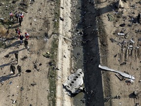 In this Jan. 8, 2020, file photo, rescue workers search the scene where an Ukrainian plane was shot down in Shahedshahr, southwest of Tehran, Iran.