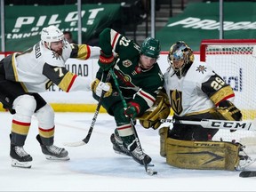 Golden Knights goalie Marc-Andre Fleury defends his net against the Wild's Kevin Fiala, centre, while Alex Pietrangelo of the Golden Knights defends in the second period in Game 4 of the First Round of the 2021 Stanley Cup Playoffs at Xcel Energy Center in St Paul, Minn., Saturday, on May 22, 2021.