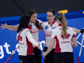 From left to right, Team Canada skip Kerri Einarson, second Shannon Birchard, third Val Sweeting, and lead Briane Meilleur celebrate their victory over China at the World Woman's Curling Championship in Calgary, Friday, May 7, 2021.