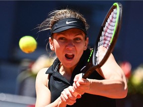 Romania's Simona Halep returns the ball to Belgium's Elise Mertens during their 2021 WTA Tour Madrid Open tennis tournament singles match at the Caja Magica in Madrid on May 4, 2021.