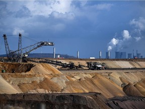 An open-cast lignite mine near the coal-fired power station Neurath of German energy giant RWE in Garzweiler, western Germany is shown on March 15, 2021. The German government said on May 5, 2021, it would set more ambitious targets to reduce CO2 emissions after a landmark ruling by the country's top court declared a flagship climate protection law "insufficient". The government now expects to slash emissions by 65 percent by 2030 compared to 1990 levels, going further than the current goal of a 55 percent reduction.