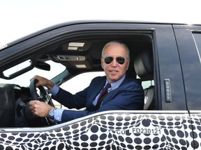 US President Joe Biden drives the new electric Ford F-150 Lightning at the Ford Dearborn Development Center in Dearborn, Michigan on May 18, 2021.