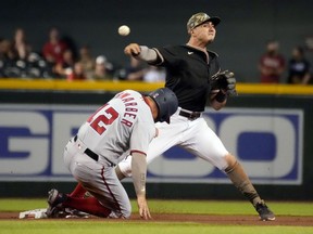 Arizona Diamondbacks third baseman Josh Rojas gets the force out on Washington Nationals left fielder Kyle Schwarber in the seventh  inning at Chase Field.
