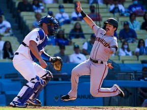 San Francisco Giants right fielder Mike Yastrzemski scores on a single by third baseman Evan Longoria (not pictured) in the fourth inning at Dodger Stadium. Los Angeles Dodgers catcher Will Smith is waiting for the late throw.
