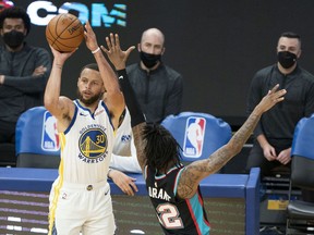 Golden State Warriors guard Stephen Curry shoots the basketball against Memphis Grizzlies guard Ja Morant during the third quarter at Chase Center.