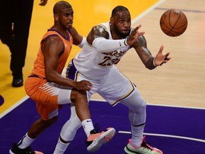 Los Angeles Lakers forward LeBron James gets the ball against the defense of Phoenix Suns guard Chris Paul during the second half in game four of the first round of the 2021 NBA Playoffs. at Staples Center.