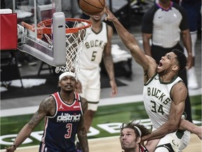 Milwaukee Bucks forward Giannis Antetokounmpo (34) scores a basket against Washington Wizards guard Bradley Beal (3) and centre Robin Lopez (15) in the fourth quarter at Fiserv Forum in Milwaukee, Wisconsin, on May 5, 2021.