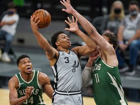 San Antonio Spurs forward Keldon Johnson shoots over Milwaukee Bucks center Brook Lopez in the second half at the AT&T Center.