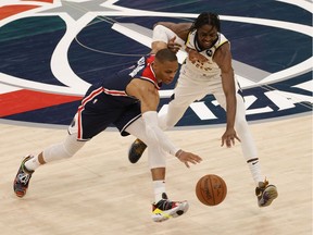 Washington Wizards guard Russell Westbrook (4) steals the ball from Indiana Pacers forward Justin Holiday (8) in the third quarter at Capital One Arena in Washington, D.C., May 3, 2021.