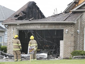 Lakeshore firefighters are shown at the scene of a house fire on Sunday, May 16, 2021 in the 100 block of Duck Creek Boulevard in Belle River. Three dogs were rescued from home. The owners were away when the fire broke out around 11 a.m.