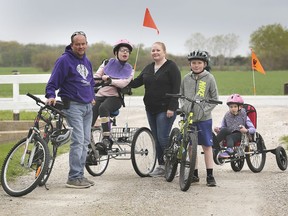 The Paquette family, from left, Brad, Tammi, Linny, Trent and Brinley are shown at their Amherstburg home on Thursday, May 6, 2021. Thanks to special bike carriers, Brinley and Tammi, who are disabled are able to enjoy the family bike rides.