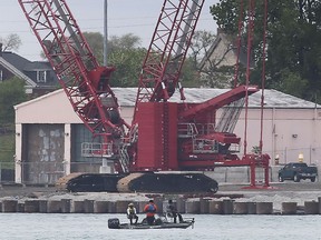 Detroit River recreational fishermen are shown in front of a section of the shoreline under repair in Detroit on Monday, May 24, 2021.