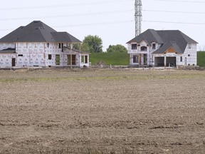 LAKESHORE, ONTARIO. MAY 20, 2021 - New homes under construction near farmland  just east of the Renaud Line is shown on Thursday, May 20, 2021. Ontario growers are worried over the rapid pace of disappearing farmland due to urban sprawl.
