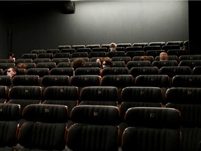 People sit at a cinema in Rome, Italy, on the day of its reopening, April 26, 2021, as much of that country became a 'yellow zone', easing coronavirus disease (COVID-19) restrictions.