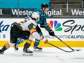 San Jose Sharks left wing Rudolfs Balcers and Vegas Golden Knights defenseman Dylan Coghlan battle for the puck during the third period at SAP Center at San Jose.