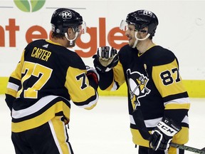 Pittsburgh Penguins centre Jeff Carter (77) and centre Sidney Crosby (87) celebrate after defeating the Buffalo Sabres at PPG Paints Arena in Pittsburgh on May 6, 2021. Pittsburgh won 8-4.