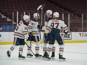 The Edmonton Oilers celebrate their victory against the Vancouver Canucks in the third period at Rogers Arena in Vancouver, on May 3, 2021. Oilers won 5-3 and clinched a playoff spot.