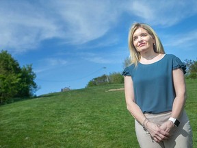 Kim Willis, spokesperson for the Windsor-Essex County branch of the Canadian Mental Health Association, stands in front of 'Suicide Hill' in Windsor's Little River Corridor on May 18, 2021. The local CMHA is holding an online contest to give the hill a more appropriate official name.