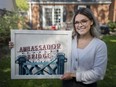 Natalie Gagne, a local artist with a focus on local landmarks, holds a piece entitled Ambassador Bridge, at her home on Thursday, May 13, 2021.