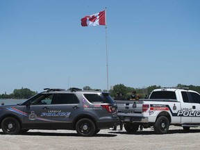 LaSalle police vehicles at Gil Maure Park wait near where a body was recovered from the Detroit River on May 30, 2021.