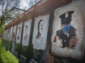 A mural honouring Howard Watkins, one of Canada's first African-Canadian detectives — one of 16 murals honouring Black history in Paterson Park — is shown defaced with blue paint, on Sunday, May 2, 2021.