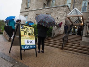 A long line of people waited for a COVID-19 vaccine outside a pop-up clinic at Mackenzie Hall in Windsor on Monday, May 3, 2021.