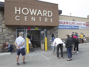 People are showing signing in and waiting outside of the Howard Medical Pharmacy in Windsor where a pop-up vaccination clinic was held on Thursday, May 27, 2021.