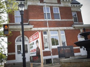 A 'for sale' sign sits in front of the historic Sandwich post office, on Monday, May 17, 2021.
