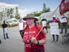 Margaret Price, an employee at Reliance Home Comfort, pickets with other employees after the HVAC company locked out their workers, on Thursday, May 13, 2021.