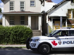 A Windsor police officer sits parked outside a residence in the 400 block of Church St., after reports of remains found, on Saturday, May 8, 2021.