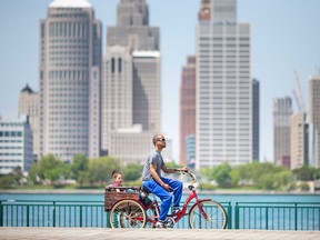 Windsor resident Reggie Jones gives his two-year-old daughter Lucie a ride on Windsor's riverfront on May 18, 2021.