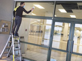 WINDSOR, ONTARIO:. MAY 28, 2021 - A worker cleans the windows at the former Sears department store at Devonshire Mall as it's being prepared for a mass vaccination site, on Friday, May 28, 2021.