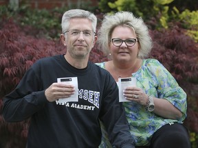 Husband and wife teachers Chris and Johanna Lawler both work with special education students and have received their COVID-19 vaccinations.They are shown with their vaccine confirmation slips on Tuesday, May 4, 2021 at their home.