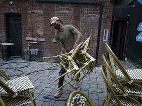 Jarrett Downey Shaw helps set up a bar patio in anticipation of the end of lockdown on June 7, 2021 in Toronto, Canada. After entering lockdown in early April amid a third wave of the coronavirus pandemic, Ontario plans to start loosening COVID-19 restrictions and reopen its economy on June 11.
