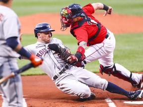 Alex Bregman of the Houston Astros is tagged out at some plate by Christian Vazquez of the Boston Red Sox in the first inning of a game at Fenway Park on June 9, 2021 in Boston, Massachusetts.