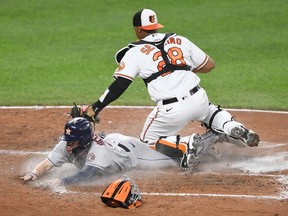 Chas McCormick of the Houston Astros beats the tag by Pedro Severino of the Baltimore Orioles and scores on a Myles Straw (not pictured0 single in the seventh inning during a baseball game at Oriole Park at Camden Yards on June 22, 2021 in Baltimore, Maryland.