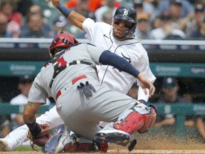 Isaac Paredes #19 of the Detroit Tigers is tagged out by catcher Yadier Molina #4 of the St. Louis Cardinals while trying to score from second base during the sixth inning at Comerica Park on June 23, 2021, in Detroit, Michigan.