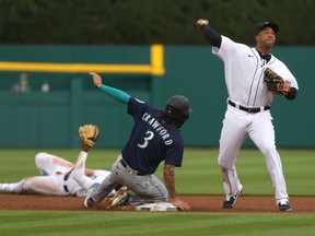 Jonathan Schoop of the Detroit Tigers tries to turn a double play around J.P. Crawford of the Seattle Mariners during the first inning at Comerica Park on June 08, 2021 in Detroit, Michigan.