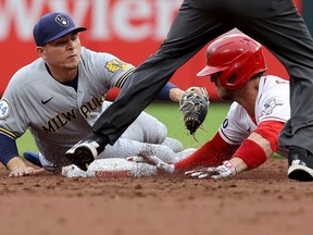 Kyle Farmer of the Cincinnati Reds slides into second base for a double past Luis Urias of the Milwaukee Brewers in the second inning at Great American Ball Park on June 08, 2021 in Cincinnati, Ohio.